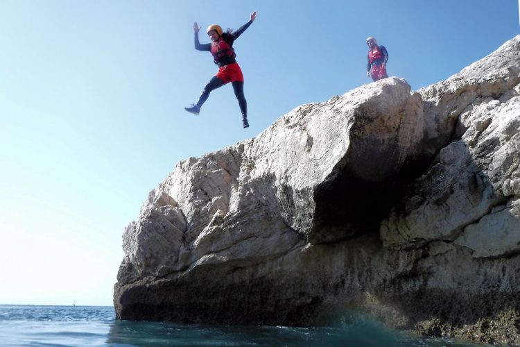 An AltaVista guest leaping to clear Atlantic waters below