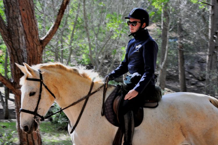 An AltaVista guest horse riding through the mountains