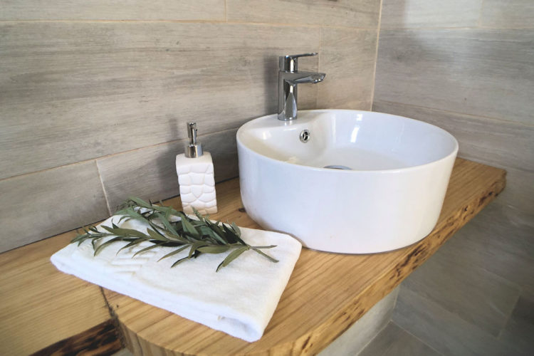 The stylish sink in the poolside room has a contemporary design