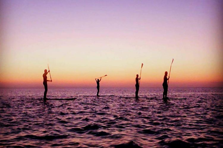 AltaVista friends enjoying a paddleboarding sunset tour
