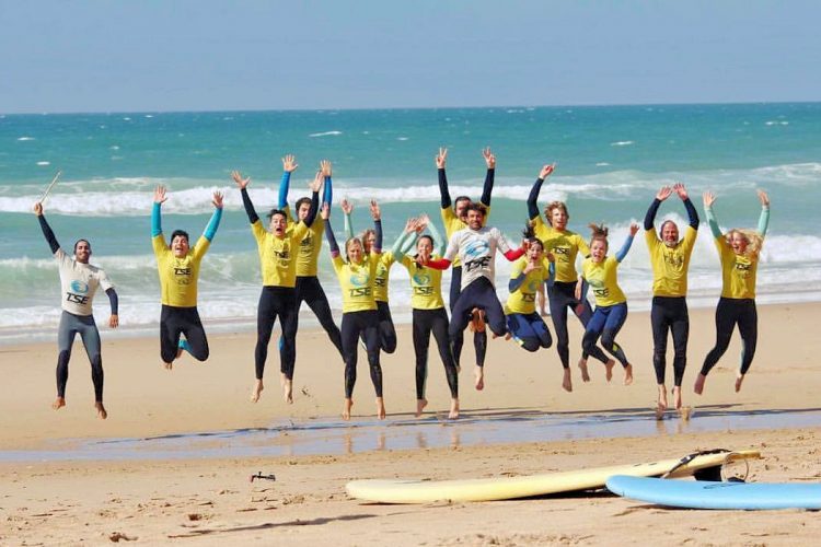 AltaVista surfers jumping for joy at the beach surf camp